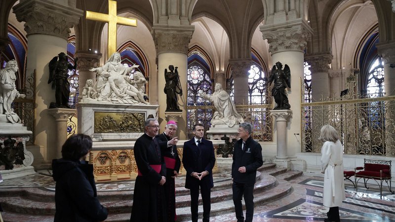 French President Emmanuel Macron, center, is seen during a visit to Notre Dame Cathedral in Paris Nov. 29, 2024. The cathedral is set to reopen in early December, with a planned weekend of ceremonies on Dec. 7 and 8, five years after the 2019 fire that ravaged the world heritage landmark and toppled its spire. Some 250 companies and hundreds of experts were mobilized for the five-year restoration costing hundreds of millions of euros. (OSV News photo/Christophe Petit Tesson, pool via Reuters)