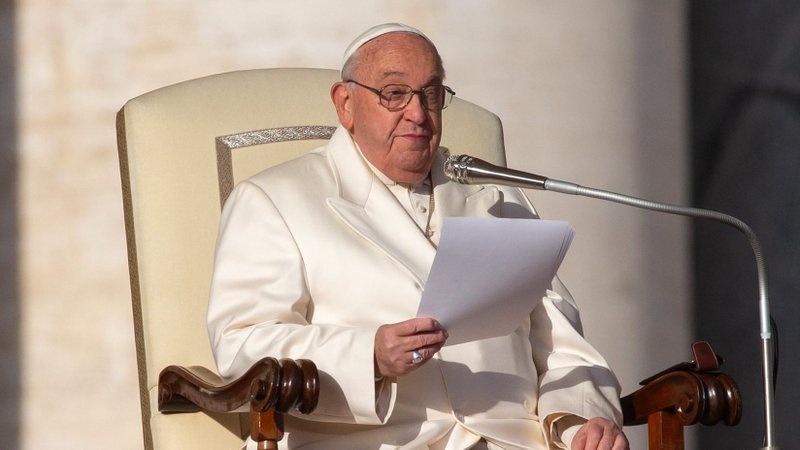 Pope Francis talks to visitors during his weekly general audience in St. Peter's Square at the Vatican Dec. 4, 2024. (CNS photo/Lola Gomez)