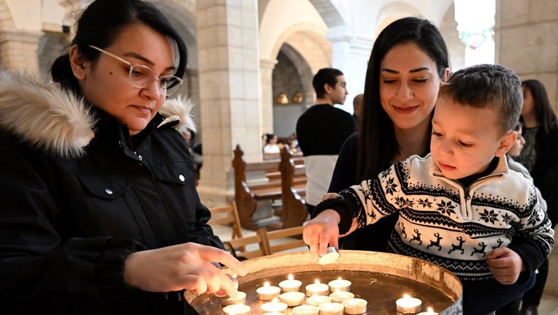 Palestinian Catholics light candles before Mass at St. Catherine Church, adjacent to the Church of the Nativity, in Bethlehem, West Bank, Dec. 17, 2023, amid the ongoing Israel-Hamas war. (OSV News photo/Debbie Hill)