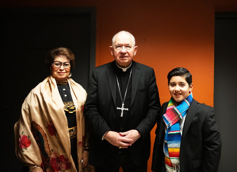 Rosa Gonzalez, left, poses with Archbishop José H. Gomez and her grandson, Sebastian, 12, after the Gonzalezes helped recite the rosary at the Las Mañanitas vigil celebrating Our Lady of Guadalupe on Dec. 11. (Victor Alemán)