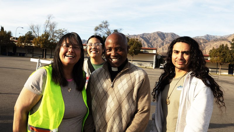 Father Michael Ume, pastor of Assumption of the Blessed Virgin Mary Church in Pasadena, with volunteers from his parish. (Victor Alemán)