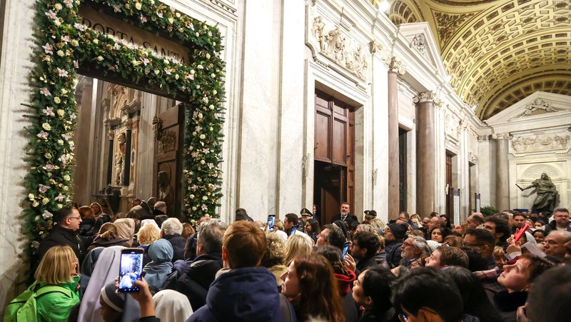 Visitors walk through the Holy Door of the Basilica of St. Mary Major in Rome Jan. 1, 2025, after its ceremonial opening by Cardinal Rolandas Makrickas, coadjutor archpriest of the basilica. (CNS photo/Lola Gomez)