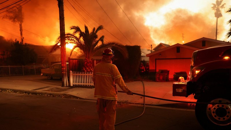A firefighter works near homes during a weather-driven windstorm in Altadena on Jan. 8, that fueled ferocious wildfires. The fires tore across Southern California, including Pacific Palisades, Sylmar and the Altadena/Pasadena area. (OSV News/David Swanson, Reuters)
