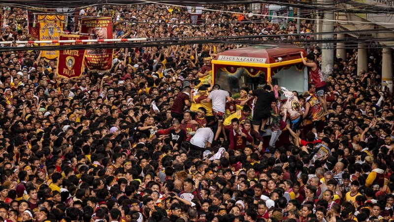 Filipino Catholics jostle to touch the carriage carrying the statue of the Black Nazarene during the annual procession on its feast day in Manila Jan. 9, 2025. The wooden statue, carved in Mexico and brought to the Philippine capital early in the 17th century, is cherished by Catholics, who believe that touching it can lead to a miracle. (OSV News photo/Eloisa Lopez, Reuters)