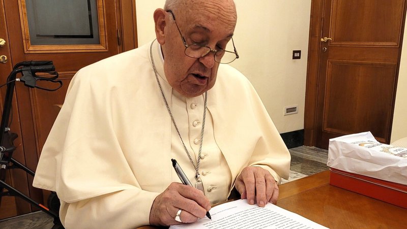 Pope Francis reviews and initials each page of the manuscript of "Hope: The Autobiography" Aug. 9, 2024, in his Vatican residence, the Domus Sanctae Marthae. The book was released in multiple languages Jan. 14, 2025. (CNS photo/courtesy of Mondadori)