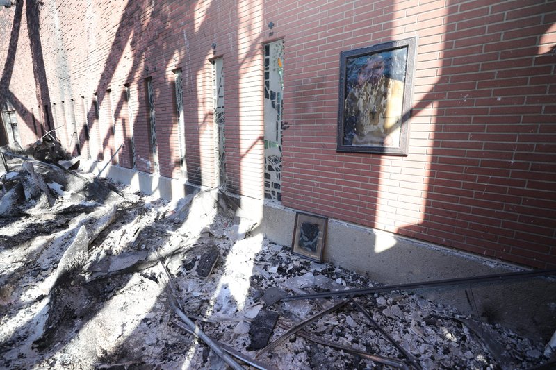 A melted photograph of Pope Francis hangs on the wall inside the destroyed Corpus Christi Church in Pacific Palisades. (OSV News photo/Bob Roller)