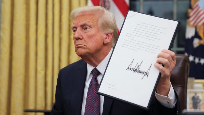 U.S. President Donald Trump signs documents in the Oval Office at the White House on Inauguration Day in Washington Jan. 20, 2025. (OSV News photo/Carlos Barria, Reuters)