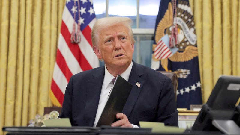 U.S. President Donald Trump signs documents in the Oval Office at the White House on Inauguration Day in Washington Jan. 20, 2025. He signed a series of executive orders including on immigration, birthright citizenship and climate. Trump also signed an order directing the U.S. government to only recognize two sexes, male and female. (OSV News photo/Carlos Barria, Reuters)