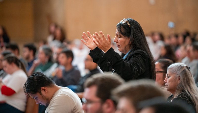 A woman raises her hands in prayer during the OneLife LA family festival Jan. 18. (Archdiocese of Los Angeles)