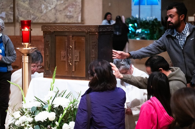 Faithful venerate the tabernacle saved from the rubble of Corpus Christi Church in the Palisades Fire during the OneLife LA celebration at the Cathedral of Our Lady of the Angels on Jan. 18. (Victor Alemán)