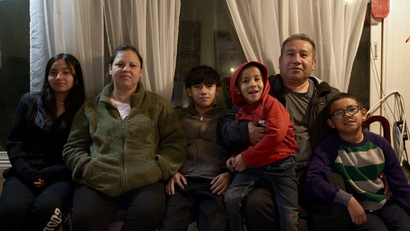 The De La Rosa family — Claudia, Raul, and their four children (with one on the way) — at a relative’s house in Altadena after losing their home to the Eaton Fire. (Reese Cuevas)