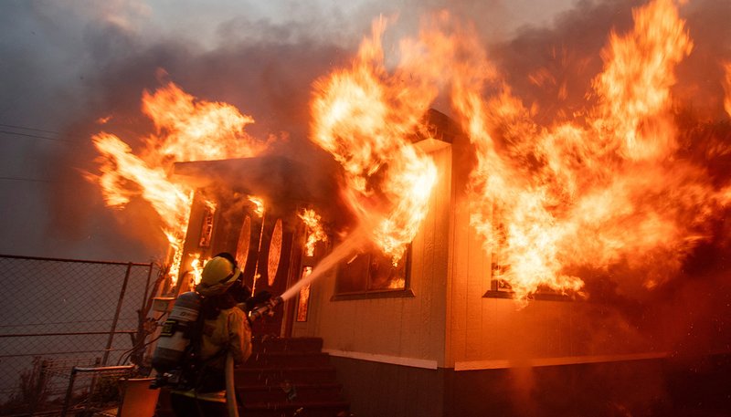 A firefighter battles the Palisades Fire as it burns during a weather-driven windstorm on the west side of Los Angeles Jan. 7. (OSV News/Ringo Chiu, Reuters)