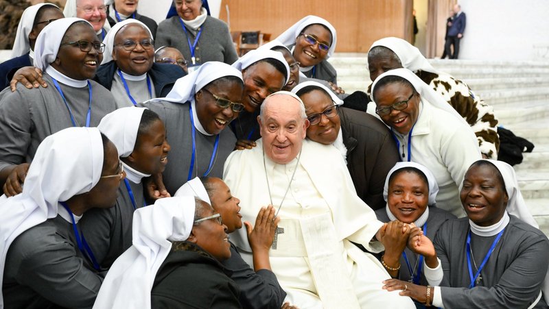 Pope Francis gathers with a group of religious sisters for a group photo at the end of his weekly general audience in the Paul VI Audience Hall at the Vatican Feb. 28, 2024. (CNS photo/Vatican Media)