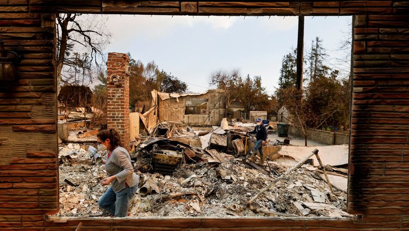 People search through the remains of a house in Altadena, Calif., Jan. 9, 2025, which was burned down by the Eaton Fire, fueled by powerful winds in the Los Angeles area. (OSV News photo/Fred Greaves, Reuters)