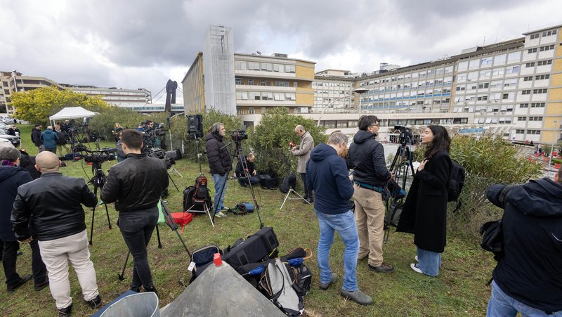Reporters, television crews and photographers gather on a hillside at Rome's Gemelli hospital Feb. 14, 2025, after Pope Francis was admitted for tests and treatment of bronchitis. (CNS photo/Pablo Esparza)