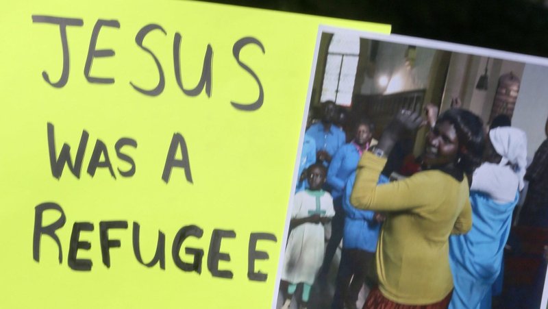 A protester holds up a sign during an Oct. 15, 2019, demonstration outside the U.S. Capitol in Washington against the first Trump administration's cuts in the number of refugees to be admitted under the U.S. resettlement program. The U.S. bishops Feb. 18, 2025, sued the second Trump administration for its abrupt halt to funds for resettling refugees. (OSV News photo/Bob Roller, CNS file)