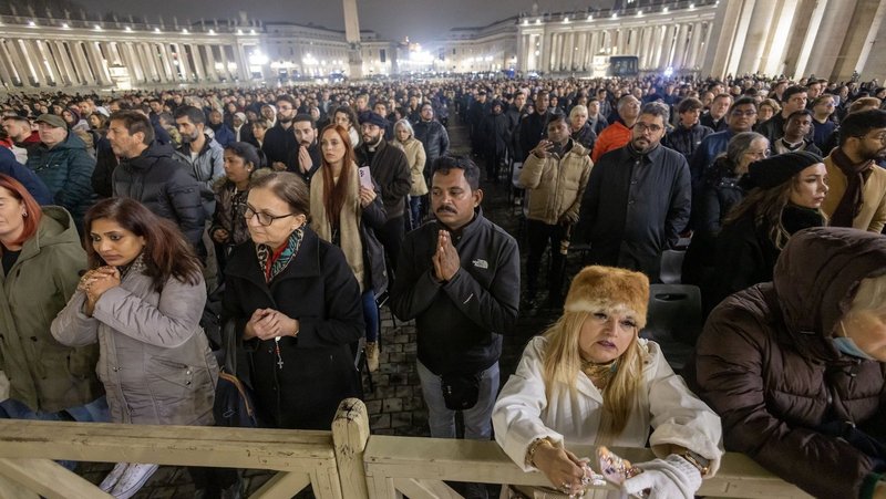 People join Cardinal Pietro Parolin, Vatican secretary of state, in reciting the rosary for Pope Francis in St. Peter's Square at the Vatican Feb. 24, 2025. Cardinals living in Rome, leaders of the Roman Curia and the faithful joined the nighttime prayer. (CNS photo/Pablo Esparza)