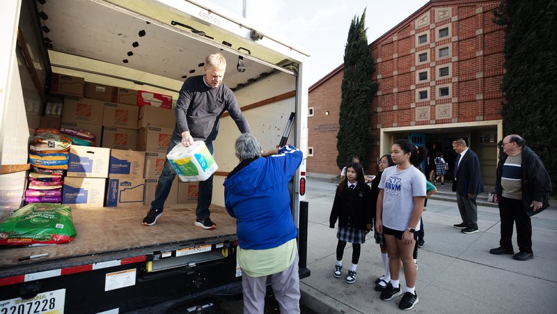 Volunteers help unload a truck from St. Michael the Archangel Church in Leawood, Kansas, with donated supplies for fire victims in Altadena on Jan. 28, 2025. (Victor Alemán)