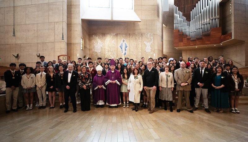 Many of the nine teachers and 72 students honored during the 2025 Christian Service Awards Mass pose with Archbishop José H. Gomez and Auxiliary Bishop Brian Nunes after the event on March 18. (Victor Alemán)