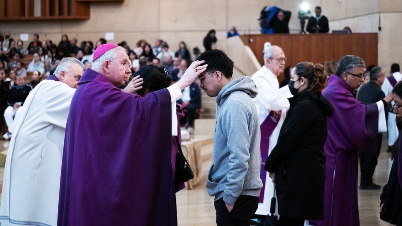 Archbishop Gomez anoints a young man with ashes at Ash Wednesday Mass at the Cathedral of Our Lady of the Angels March 5. (Victor Alemán)