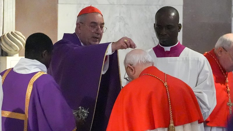 Cardinal Angelo De Donatis, head of the Apostolic Penitentiary, sprinkles ashes on the had of another cardinal during Ash Wednesday Mass at the Basilica of Santa Sabina in Rome March 5, 2025. Pope Francis, who is hospitalized, asked Cardinal De Donatis to preside at the liturgy in his stead. (CNS photo/Lola Gomez)