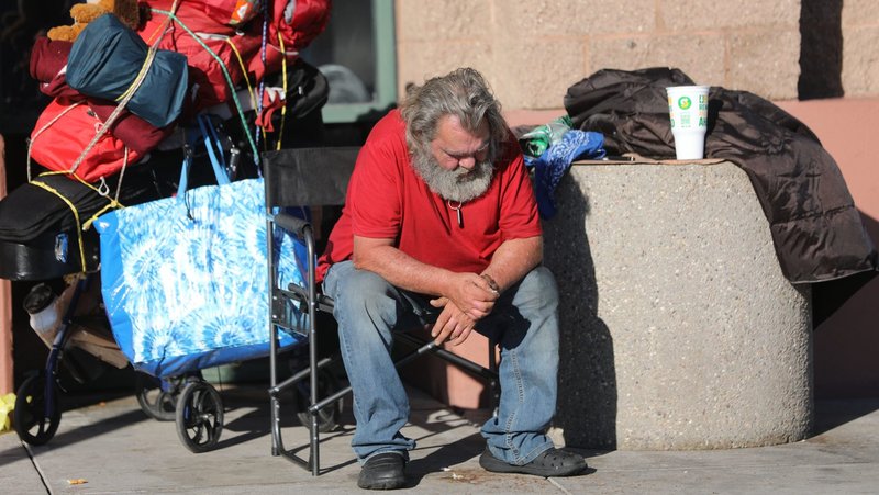 A homeless man sits with his belongings outside a shopping center in Tucson, Ariz., Oct. 22, 2023. Lent marks a call to live out God's love by supporting those in desperate need across the globe, the chairman of the U.S. bishops' Committee on International Justice and Peace said in a statement released on Ash Wednesday, March 5, 2025. (OSV News photo/Bob Roller)