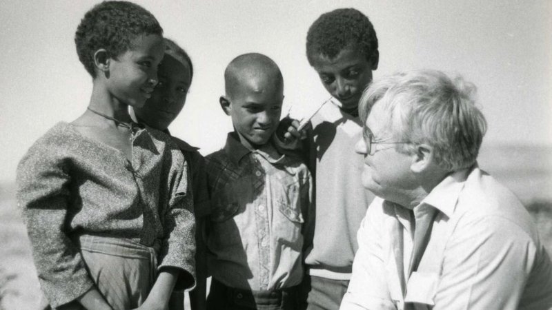 In this undated photo, Msgr. Robert Coll, creator of the Rice Bowl Lenten initiative, speaks with youth during a Catholic Relief Services mission to African nations. Msgr. Coll started Rice Bowl in 1975 as a means of countering hunger while deepening campaign participants' faith. (OSV News photo/courtesy Archdiocese of Philadelphia/Al and Camille St. Pierre)