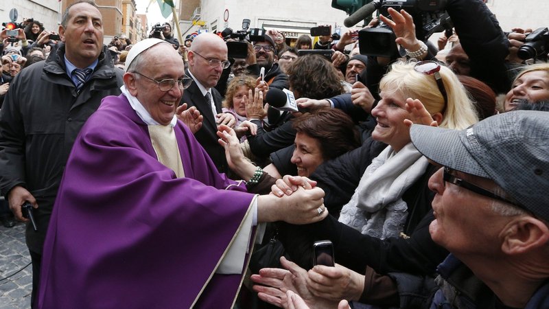 Pope Francis smiles as he greets people after celebrating Mass at the Church of St. Anne within the Vatican March 17, 2013. The pope wants the church to be holy and joyful. (CNS photo/Paul Haring)