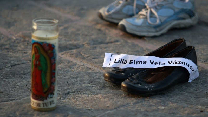 A a file photo in Monterrey, Mexico, shows a candle with an image of Our Lady of Guadalupe and pairs of shoes with a name tag of its owner, a victim of the drug war. In a statement shared March 12, 2025 the Mexican bishops' conference expressed outrage over the discovery of an extermination camp operated by a drug cartel, calling it "one of the cruelest expressions of evil and human misery that we've seen in the country," and alleging such sites exist in other parts of Mexico. (OSV News photo/Daniel Becerril, Reuters)