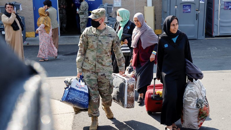 U.S. Army soldiers at the Dulles Expo Center in Chantilly, Va., assist Afghanistan families as they depart an evacuees' processing center Aug. 25, 2021. A federal judge has denied a request from the U.S. Conference of Catholic Bishops to compel the Trump administration to reinstate its contracts with the conference and resume paying it for expenses for resettling refugees in the United States. The bishops are appealing the March 11, 2025, ruling. (OSV News photo/Jonathan Ernst, Reuters)