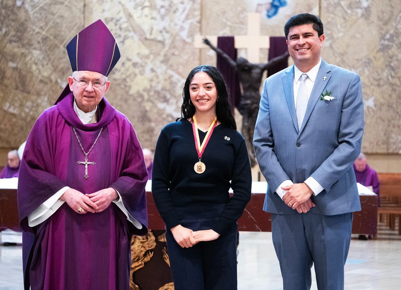 Renee Taylor of Notre Dame High School in Sherman Oaks poses with Archbishop José H. Gomez and Superintendent of Catholic Schools Paul Escala at the Christian Service Awards Mass on March 18. (Victor Alemán)
