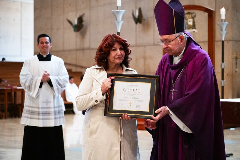 Yolanda Morales, a teacher at St. Joseph High School in Lakewood receives her award from Archbishop José H. Gomez during the Christian Service Awards Mass on March 18. (Victor Alemán)