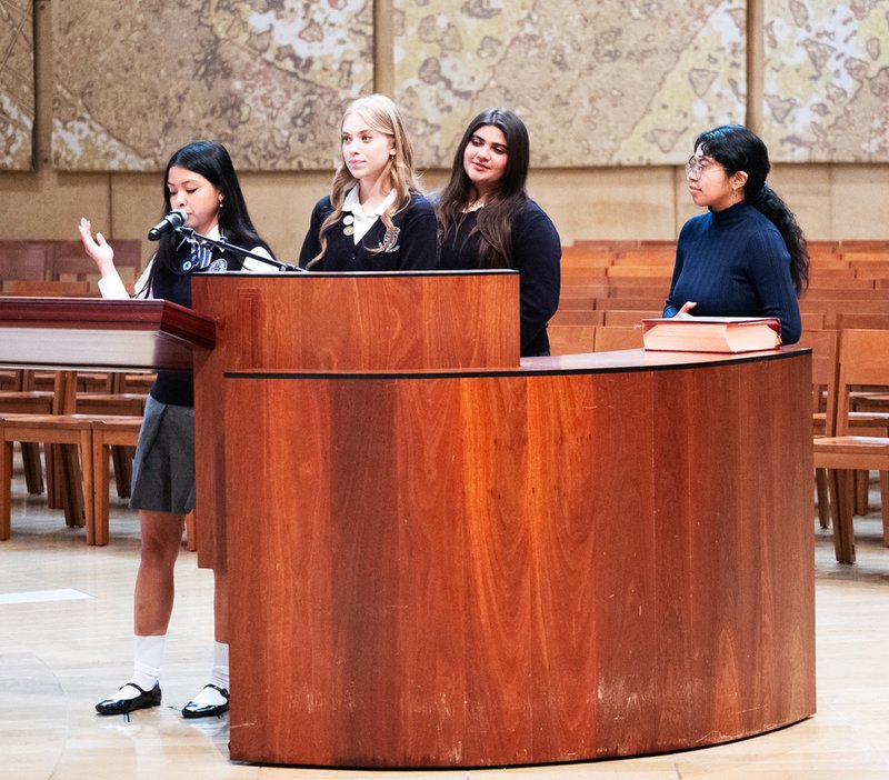 Sophia Rodriguez, front, from St. Genevieve High School in Panorama City, reads the Prayers of the Faithful during the Christian Service Awards Mass. Behind her is Abigail Johnson from St. Lucy’s Priory High School in Glendora, and Isabelle Soto from Santa Clara High School in Oxnard. To the right is Marcela Quiju, assistant liturgy director at the cathedral. (Victor Alemán)