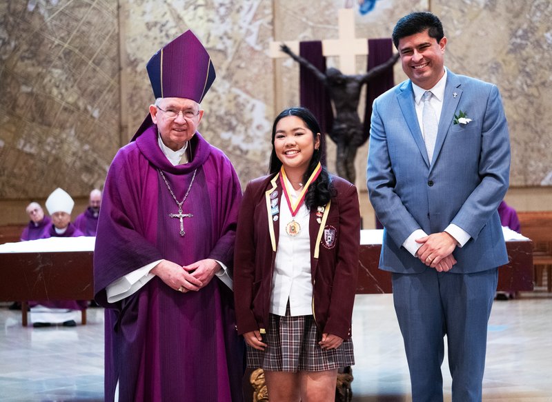Carmela Torralba of Bishop Conaty-Our Lady of Loretto High School in Los Angeles poses with Archbishop José H. Gomez and Superintendent of Catholic Schools Paul Escala at the Christian Service Awards Mass on March 18. (Victor Alemán)