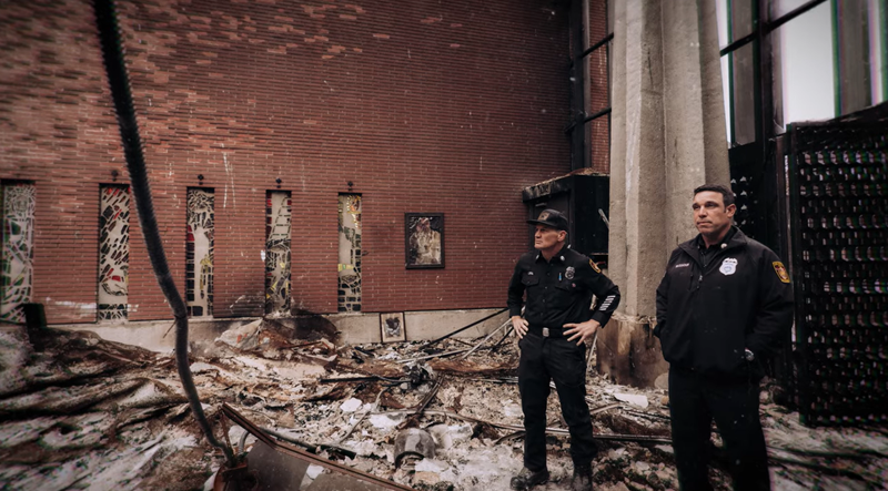 Los Angeles Fire Department Capt. Brian Nassour and Capt. Frank V. Lima stand inside the burned-down Corpus Christi Church in Pacific Palisades. (Archdiocese of Los Angeles)