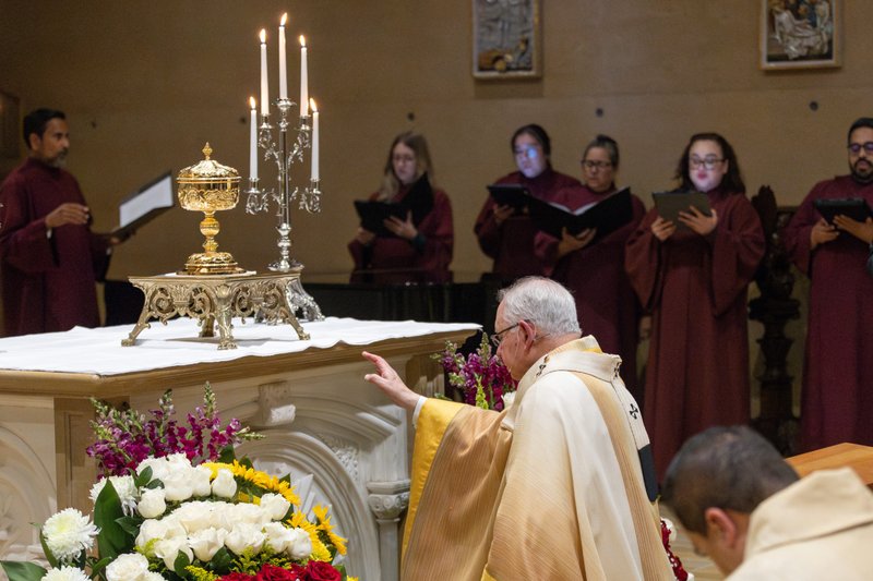 Archbishop José H. Gomez kneels in front of the Eucharist at the Cathedral of Our Lady of the Angels on Holy Thursday, April 17. (Will Jobe)