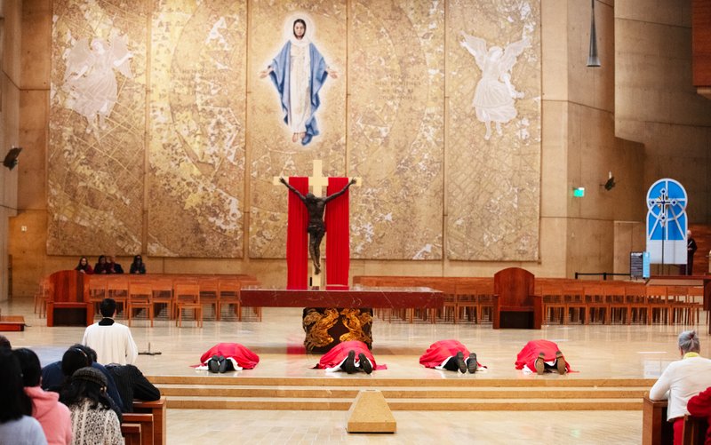 Archbishop José H. Gomez and other priests prostrate themselves in front of the cross during a Good Friday liturgy at the Cathedral of Our Lady of the Angels on April 18. (Victor Alemán)