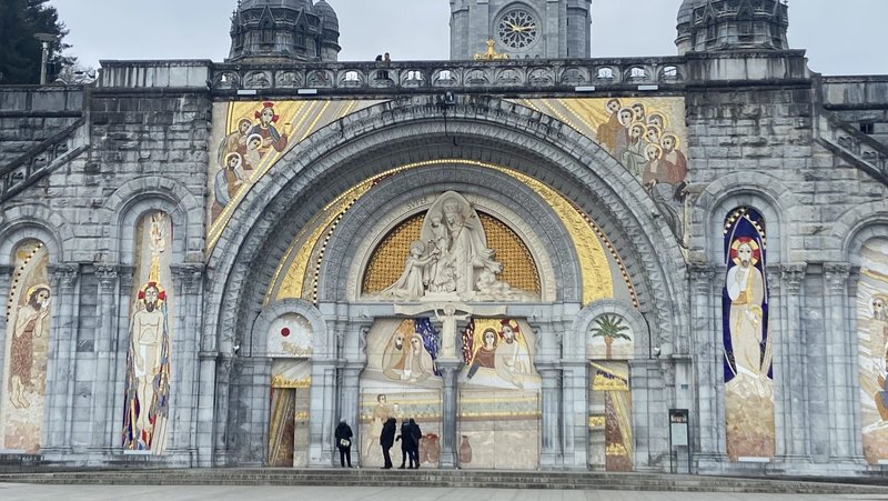 The uncovered facade of the Basilica of Our Lady of the Rosary is pictured at the Sanctuary of Our Lady of Lourdes in southwestern France in April 2023. The facade showcases the artwork of Father Marko Rupnik, a priest and former Jesuit, who is currently under investigation after accusations of spiritual, psychological and sexual abuse by multiple adult women. Bishop Jean-Marc Micas of Tarbes and Lourdes said March 31, 2025, that the sanctuary will cover the mosaics on the door of the basilica. (OSV News photo/courtesy Greg Erlandson)