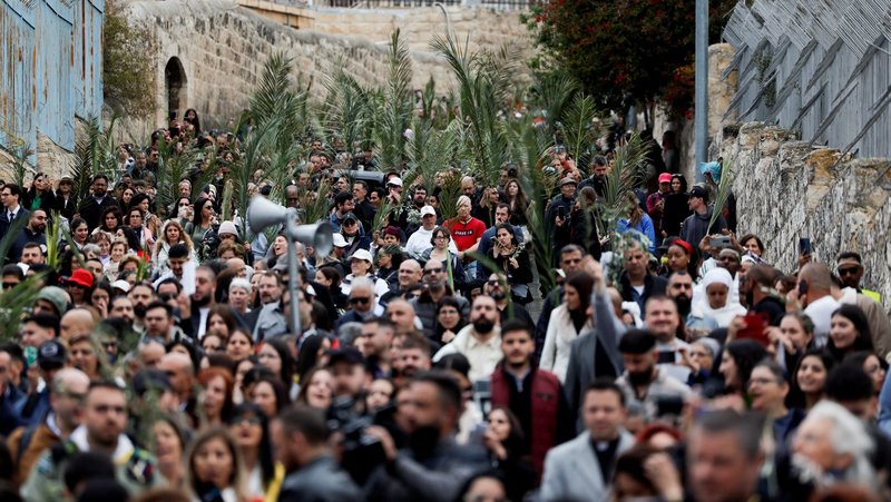 Christians wave palm and olive branches as they walk the traditional path that Jesus took on his last entry into Jerusalem during the Palm Sunday procession on the Mount of Olives April 13, 2025. (OSV News photo/Ammar Awad, Reuters)