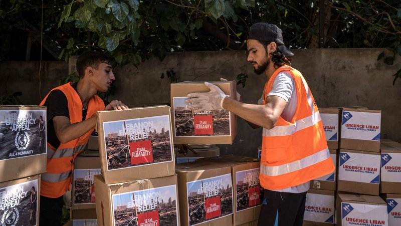 Workers with Caritas Lebanon, in partnership with Catholic Relief Services, are pictured in an undated photo distributing food and hygiene kits to people who affected following an Aug. 4, 2020, blast in Beirut's port area. (OSV News photo/Stefanie Glinski for Catholic Relief Services)
