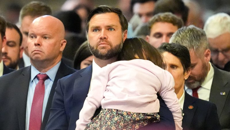 U.S. Vice President JD Vance holds his daughter as he attends the Liturgy of the Lord’s Passion in St. Peter’s Basilica at the Vatican April 18, 2025. (CNS photo/Lola Gomez)