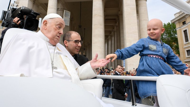 Pope Francis greets a child from the popemobile after giving his Easter blessing to thousands of people in St. Peter's Square at the Vatican April 20, 2025. Pope Francis, formerly Argentine Cardinal Jorge Mario Bergoglio, died April 21 at age 88. (CNS photo/Vatican Media)