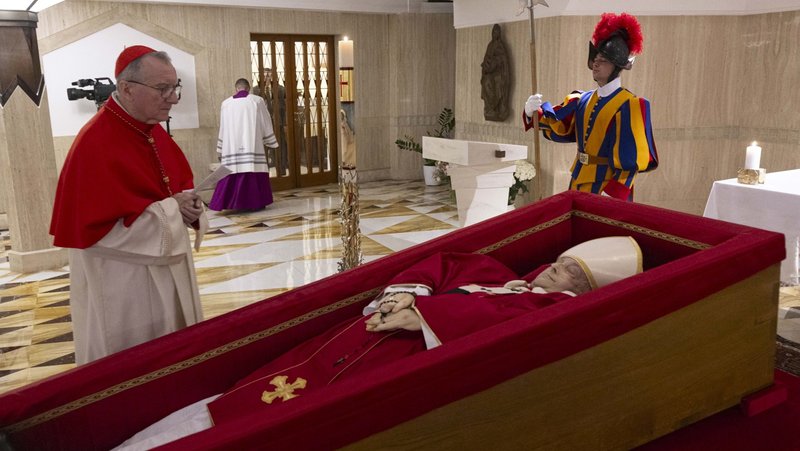 Cardinal Pietro Parolin, who served as Pope Francis' secretary of state, stands by the pope's coffin in the chapel of his residence, the Domus Sanctae Marthae, at the Vatican April 21, 2025. (CNS photo/Vatican Media)