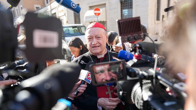 Retired Italian Cardinal Gianfranco Ravasi, speaks with the press as he approaches the Petriano entrance next to St. Peter's Square to attend the first meeting of cardinals in the Synod Hall at the Vatican April 22, 2025. (CNS photo/Lola Gomez)