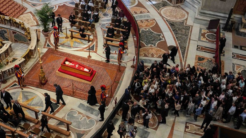 People gather inside St. Peter’s Basilica at the Vatican April 23, 2025, to view the body of Pope Francis on the first day of public visitation. The casket will stay open for three days of public viewing and prayer ahead of his funeral Mass April 26. (CNS photo/Lola Gomez)