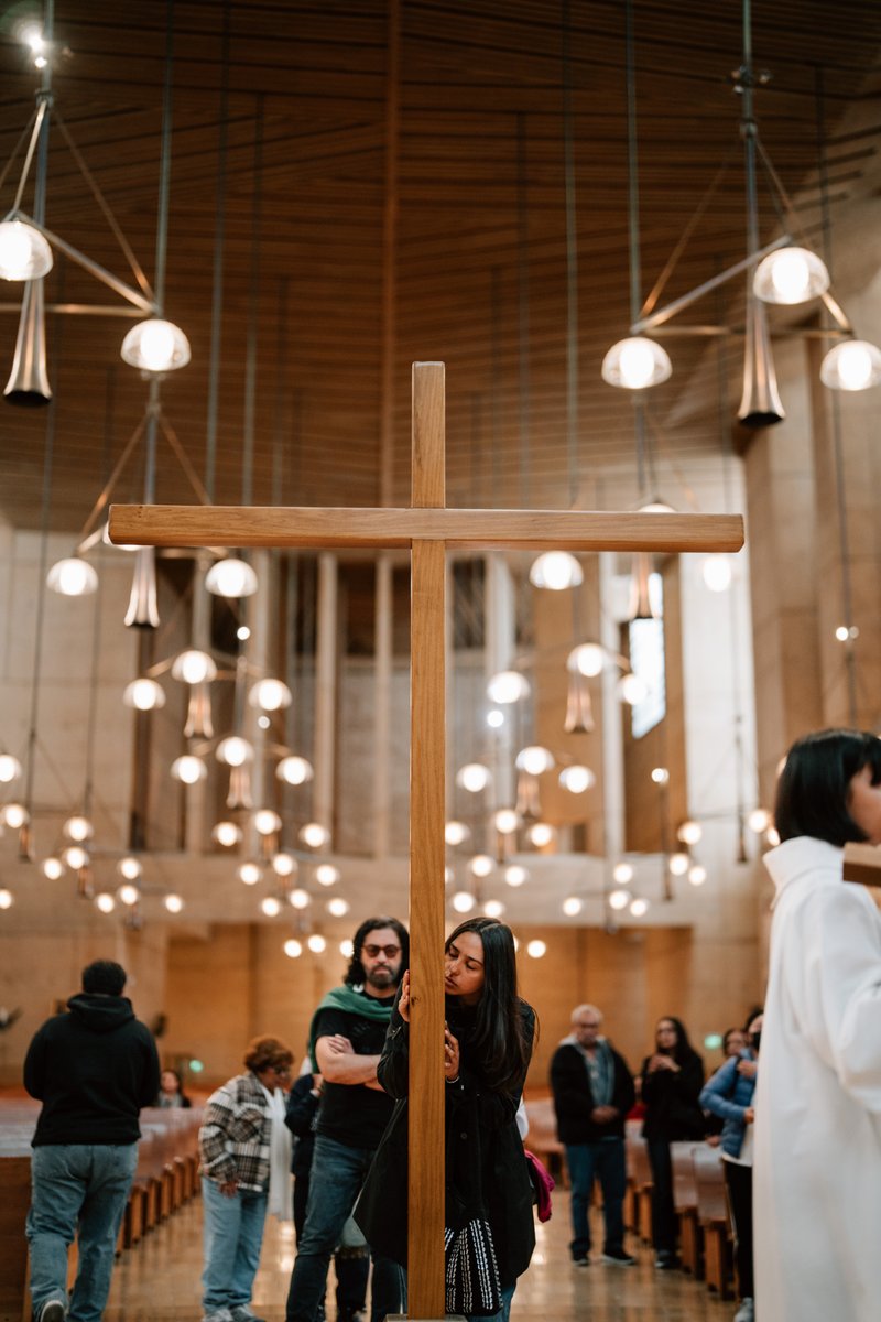 Attendees venerate in front of the cross during a Good Friday liturgy at the Cathedral of Our Lady of the Angels on April 18. (Peter Lobato)