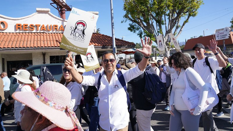An LA Catholic waves on the seven-mile pilgrimage from All Souls Church in Alhambra to the Cathedral of Our Lady of the Angels April 5. (Isabel Cacho)