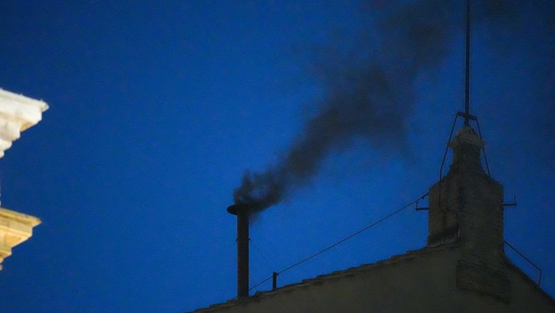 Black smoke billows from the chimney atop the Sistine Chapel May 7, 2025, on the first day of the conclave at the Vatican. (CNS/Lola Gomez)