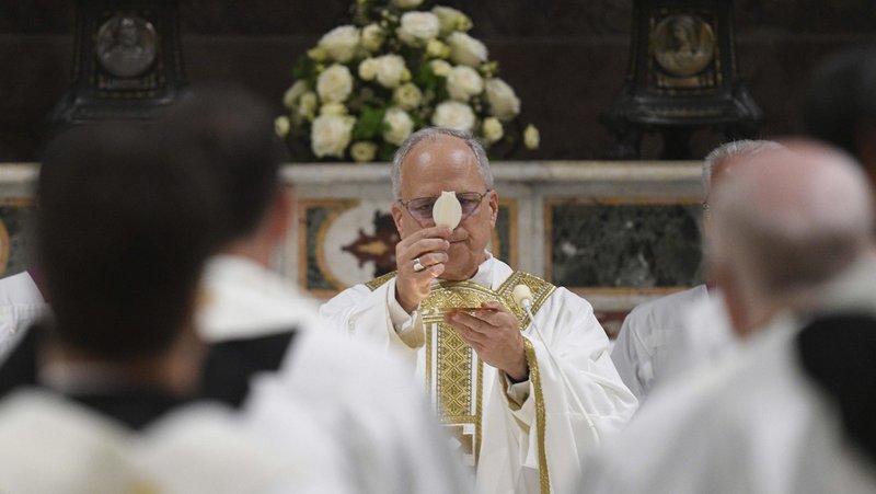 Pope Leo XIV elevates the host as he celebrates his first Mass as pope with the cardinals who elected him in the Sistine Chapel at the Vatican May 9, 2025. (CNS photo/Vatican Media)
