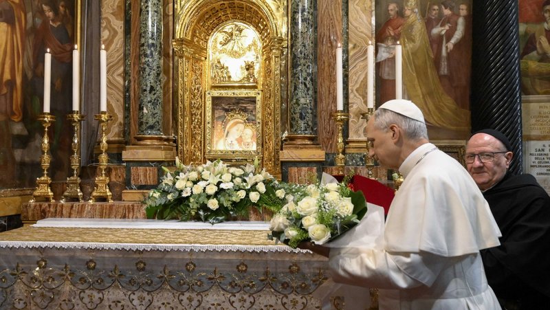 Pope Leo XIV brings flowers to set under a Marian fresco in the Shrine of Our Lady of Good Counsel in Genazzano, Italy, southeast of Rome, May 10, 2025. The shrine, with a famous image of Mary, is run by the pope's Augustinian confreres. (CNS photo/Vatican Media)